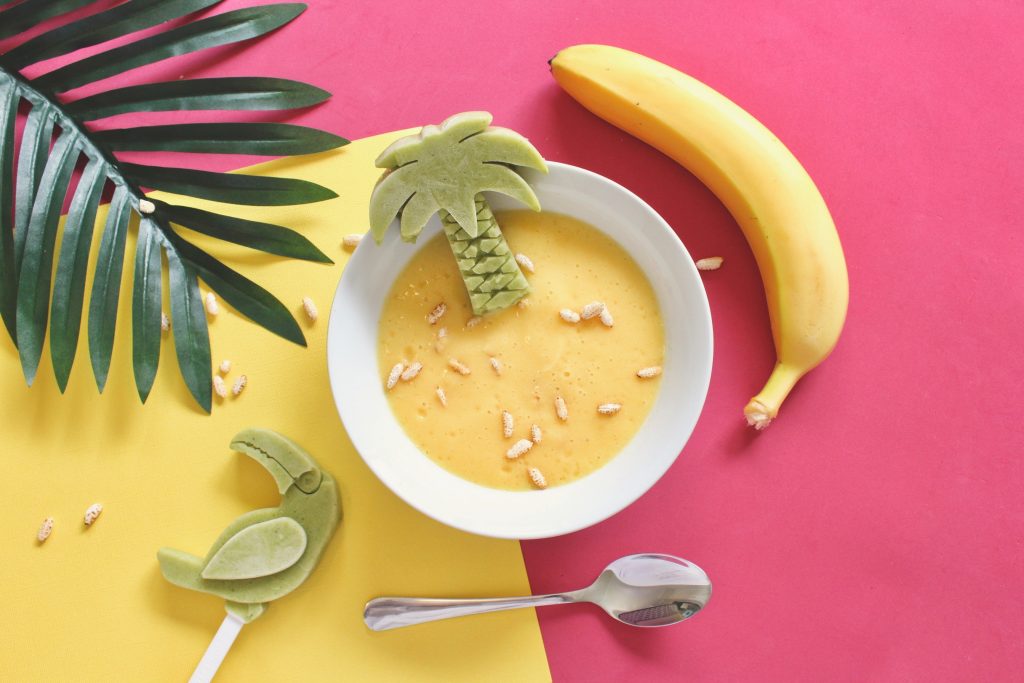 Bright image of banana and bowl of food for a child